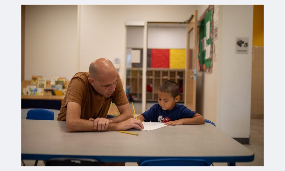 A preschool teacher guides a child in a drawing activity, representing brain-science backed activities in EGG Toolkit that strengthen executive function and early learning skills.