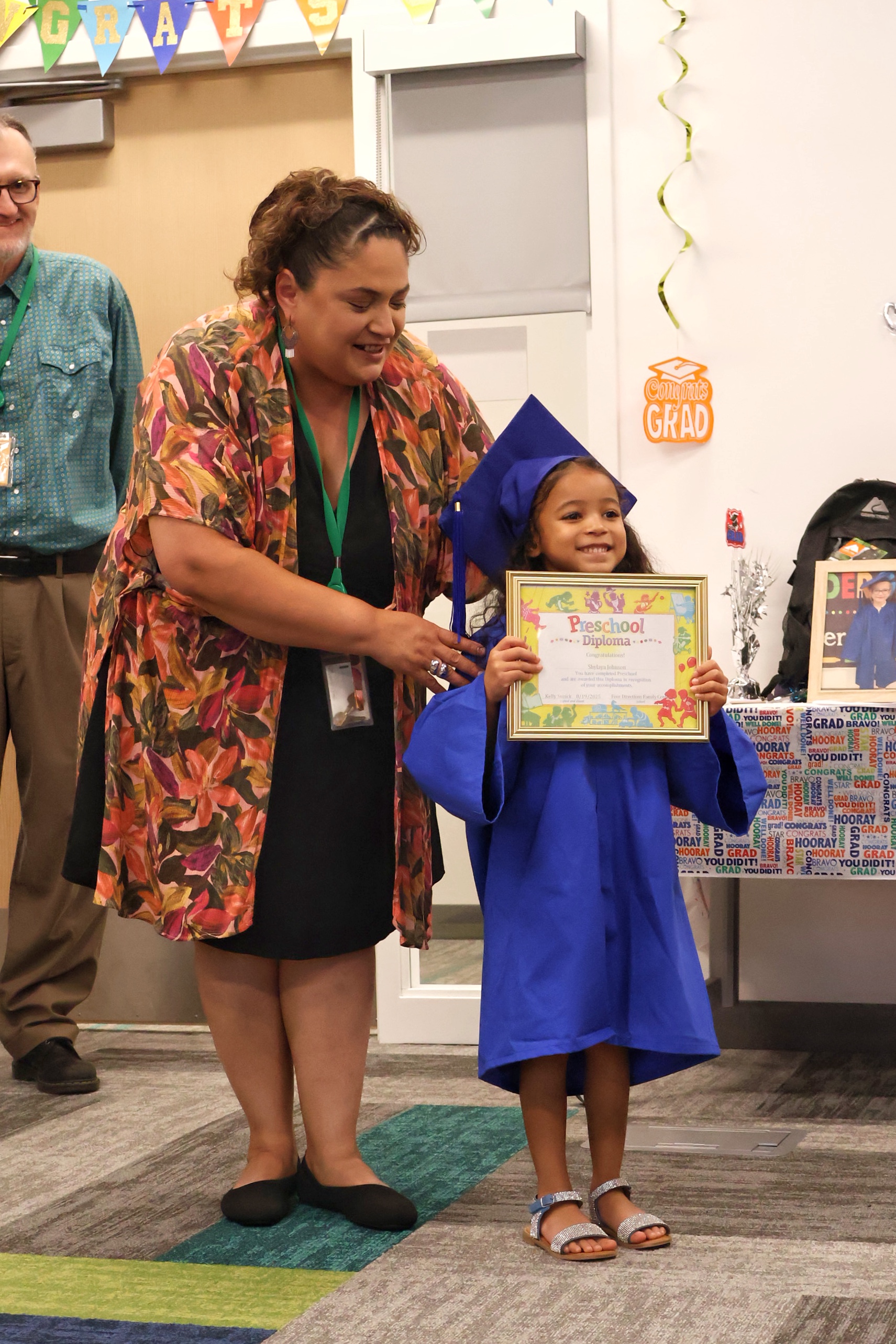 Kelly Suzick, Assistant Director of Four Directions Preschool, celebrates a recent graduate who is kindergarten-ready.